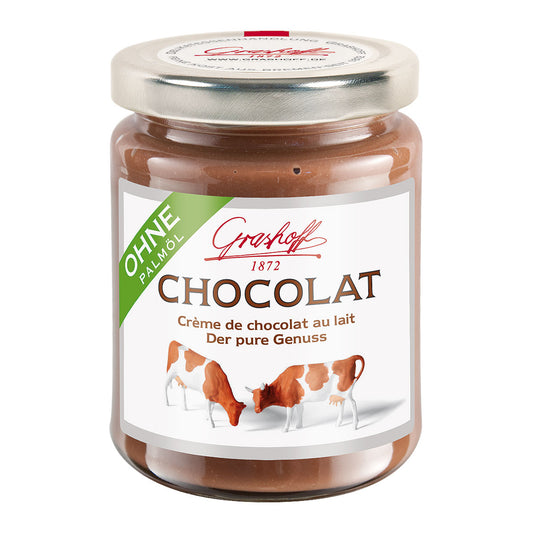 Glas mit Milchchocolat und kleinen Kühen