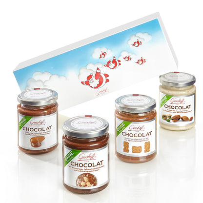 Sie sehen ein Bild mit 4 Chocoladencreme und einem Weihnachtlichen Präsentkarton