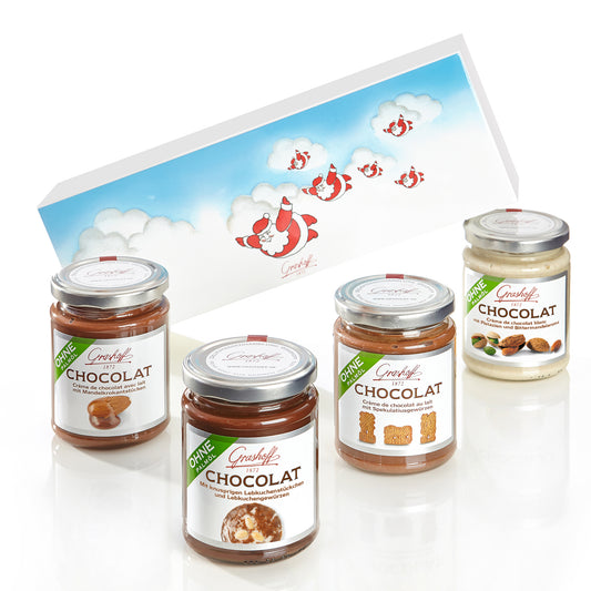 Sie sehen ein Bild mit 4 Chocoladencreme und einem Weihnachtlichen Präsentkarton